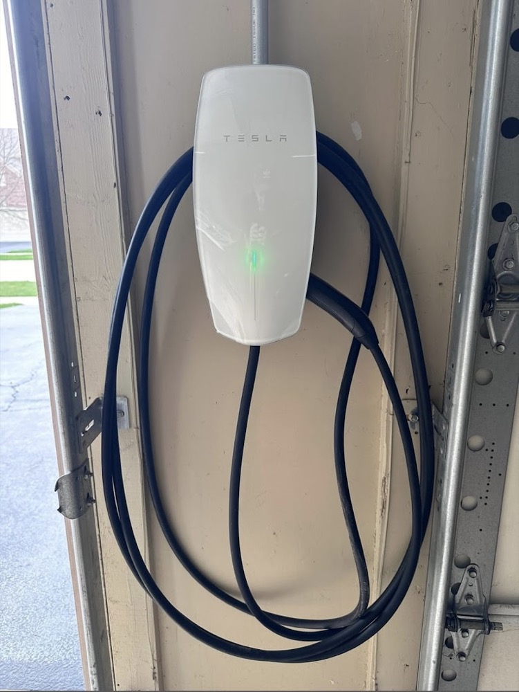 Tesla Wall Connector EV charger installed in a garage by Rescue Electric